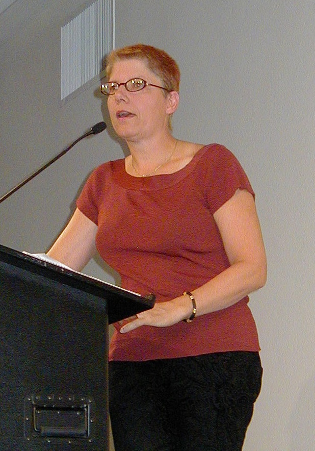Bo Laurent speaking at a lectern during the years of intersex advocacy